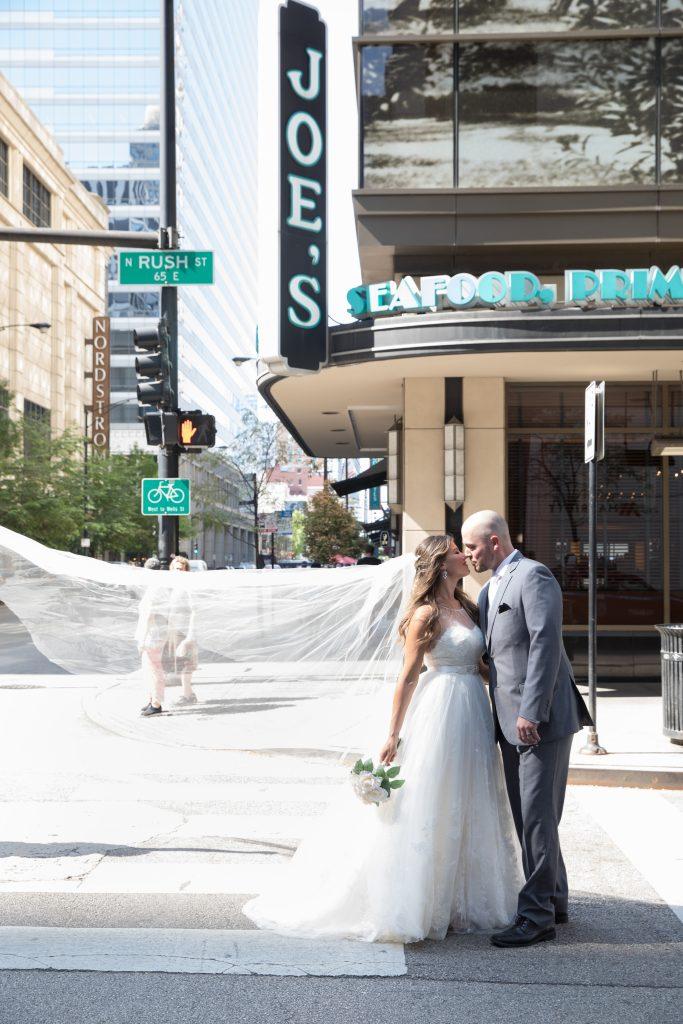 a bride and groom standing in front of joes seafood restaurant