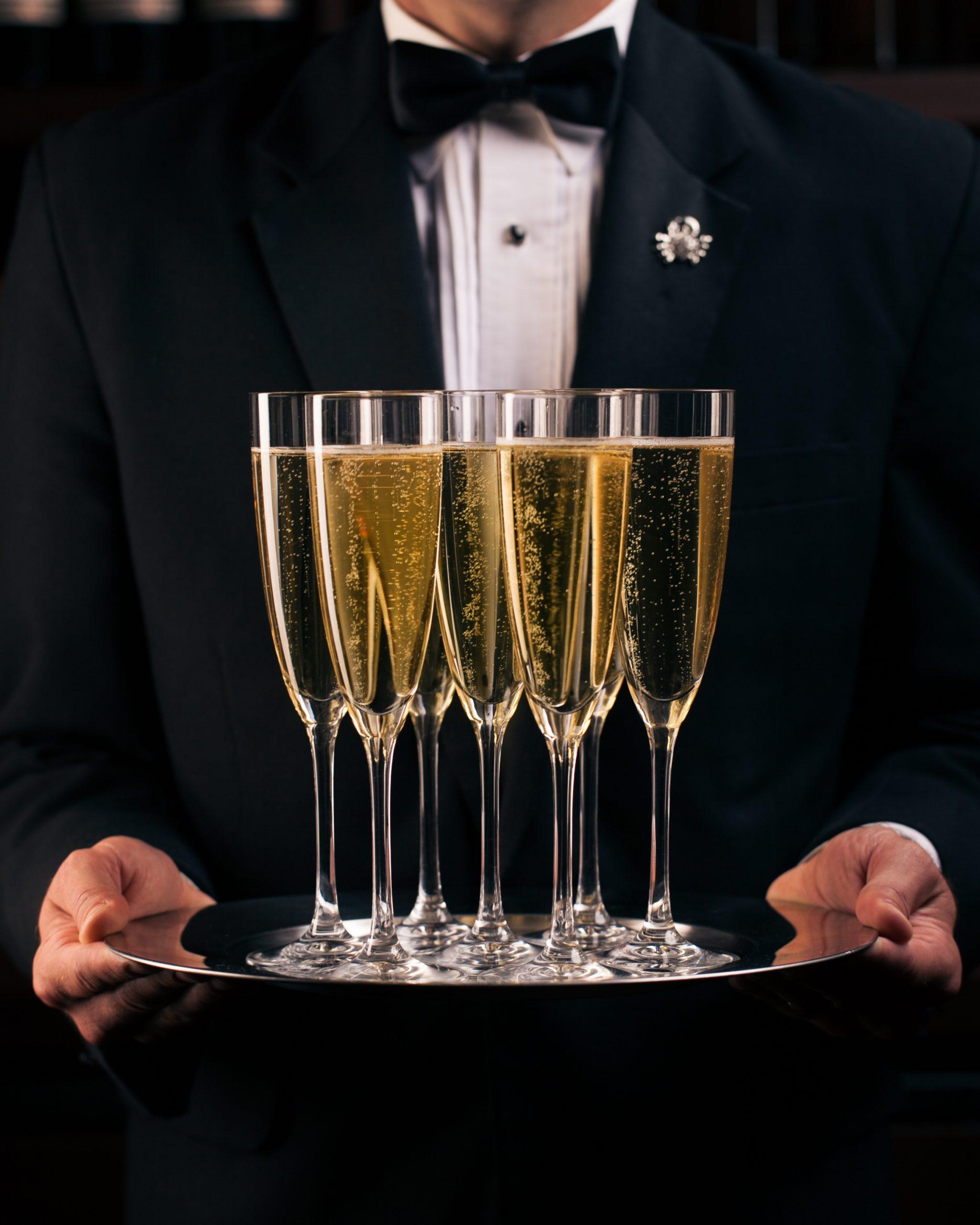 joes server holding champagne glasses